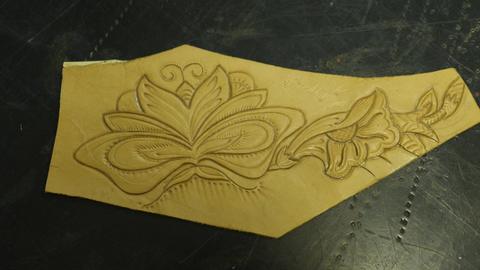 A tooled floral design on undyed leather