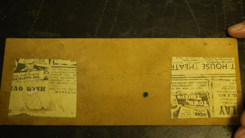 The back of a panel, with newspaper still glued to it