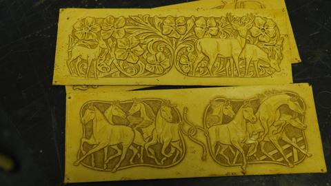 Two carved panels: horses and deer among flowers