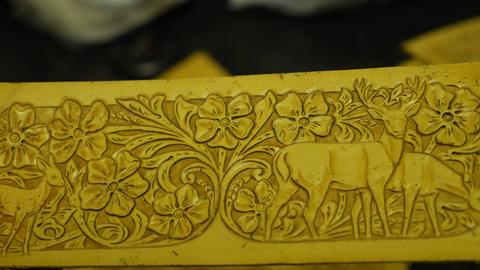 A carved floral panel with deer