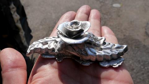 The rose casting from the side, showing the depth of the petals