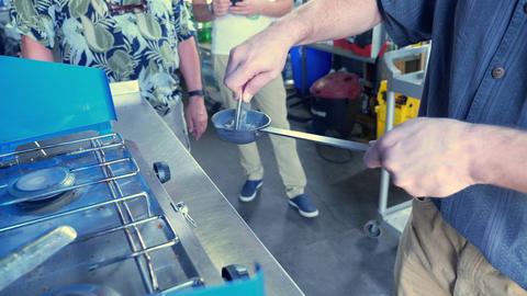 Ladling molten pewter at the stove