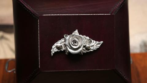 The case's pewter rose and leaf mount