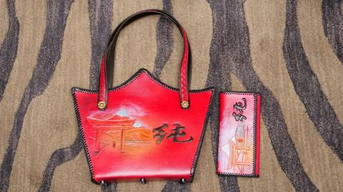 Lester Pinter's Associate entry: a painted red handbag with a matching case