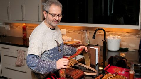 A judge examining a carved bag