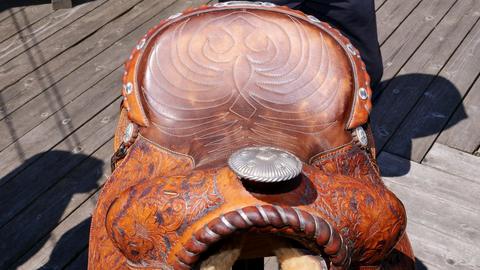 The tooled seat of a Western saddle