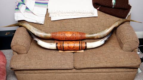 Mounted longhorns with a carved leather wrap