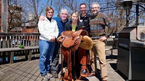 Judges and entrant with the saddle