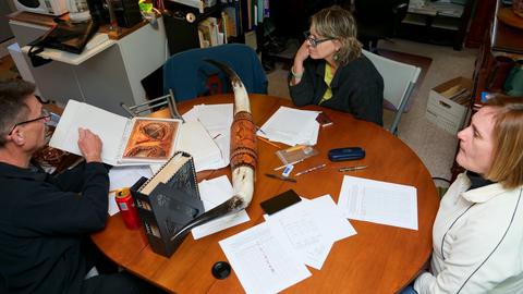 The judges at work, a carved piece in hand