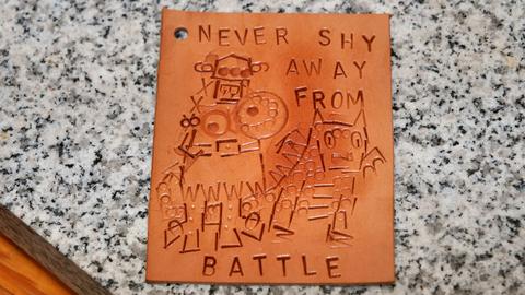 A stamped tag: “Never shy away from battle”