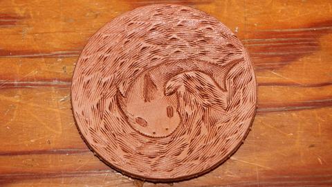 A stamped coaster with a unicorn