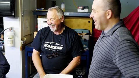 Two men laugh together during the lasting boxes workshop