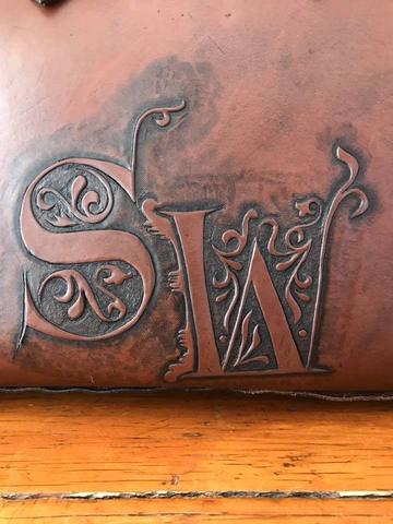 The bag's carved monogram