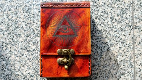 Leather tarot card case, front, laser-engraved eye in a triangle and a brass clasp