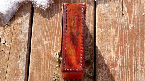 Leather tarot card case seen from the side, showing the stitched walls