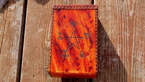 Leather tarot card case, back, laser-engraved pentagram with the four elements